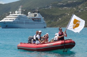 The captain and crew of the Seabourn Spirit bringing champagne and caviar from the ship.